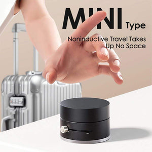 Black cylindrical device with a hand reaching towards it, suitcase in the background, text about noninductive travel.